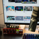 A professional streaming set up including a monitor, sound mixer, keyboard and high quality microphone.